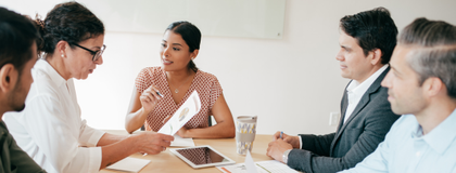 Five people around a table.