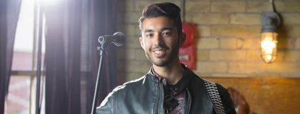 man smiling infront of microphone