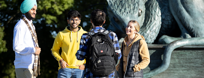 International students chat at the Gryphon Statue