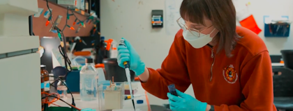 a person uses a pipette in a lab