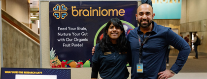 2 people standing in front of a poster board