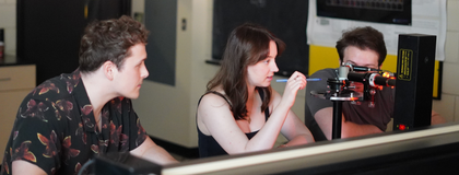 students in the lab working on electronics equipment