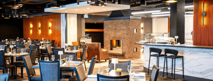 University club chairs, tables, bar and fireplace