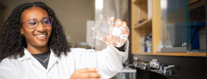 Student pours beaker