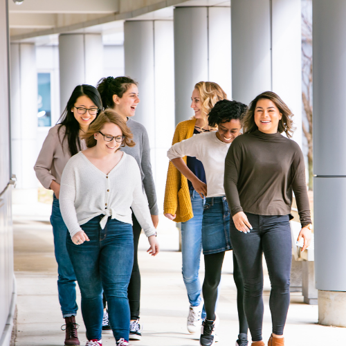 Six students walking together by the Summerlee Science Complex.