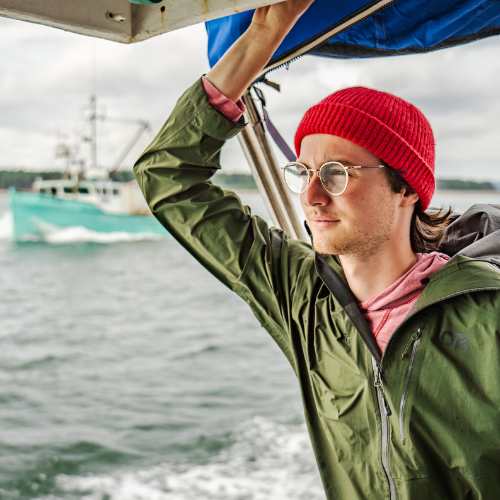 A student participating in a field course aboard a boat in the open ocean.