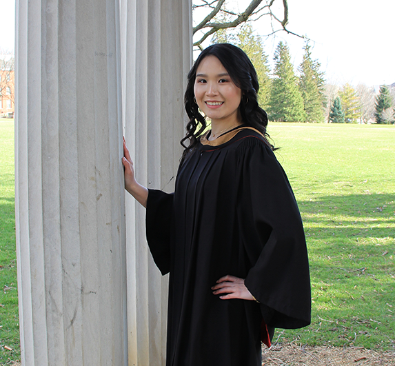 aleana, standing at the portico on johnston green, wearing a gown