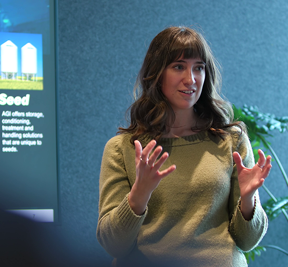 mikayla in  a boardroom giving a speech