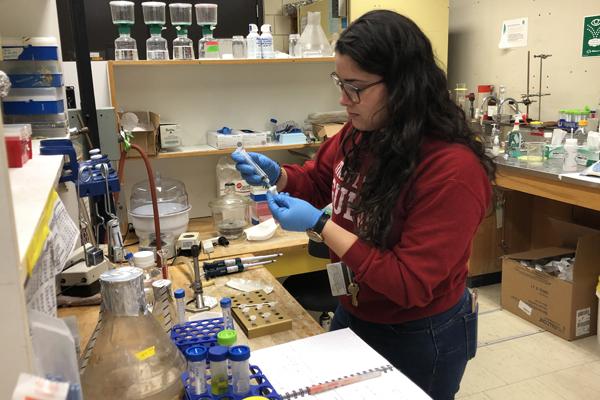 scientist using syringe to inject samples in the lab