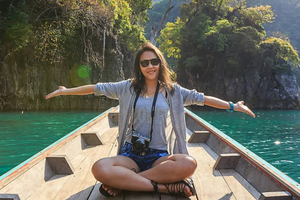A girl on a boat in a canal.