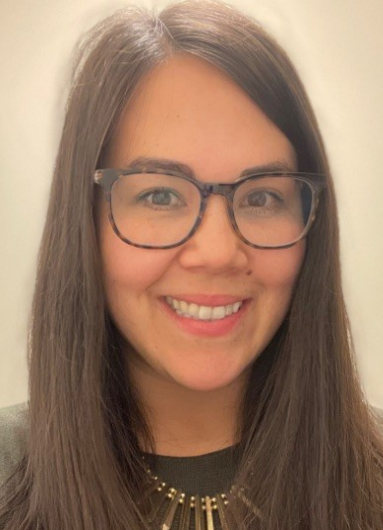 Woman with long dark hair and glasses