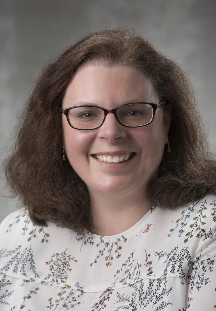 Headshot of Dr. Stacey Scott with Summerlee Science Complex in the background