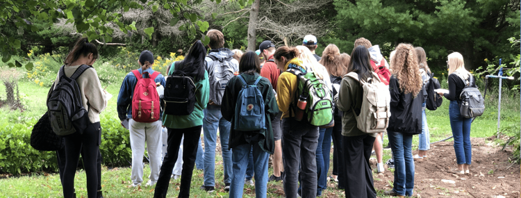 students touring the organic farm