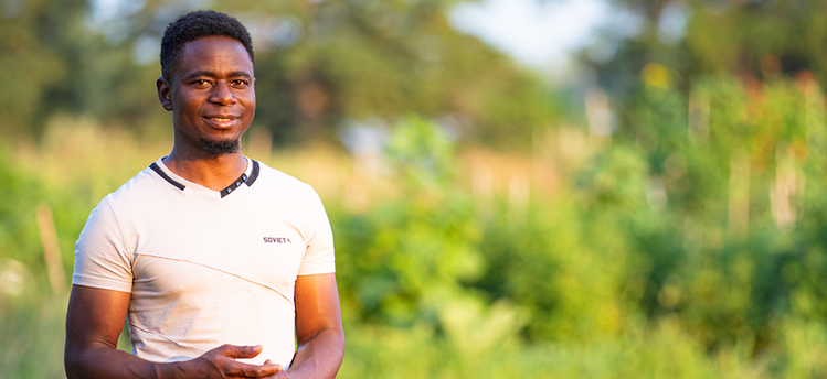 a student standing in a field