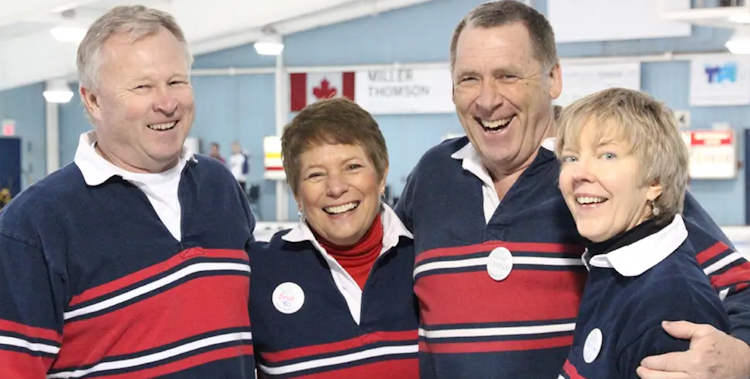 oac alumni at a curling club, with arms around each other