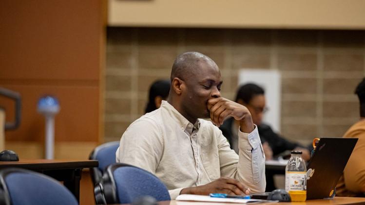 man sitting in lecture hall