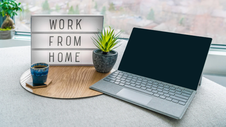 work from home sign beside a computer
