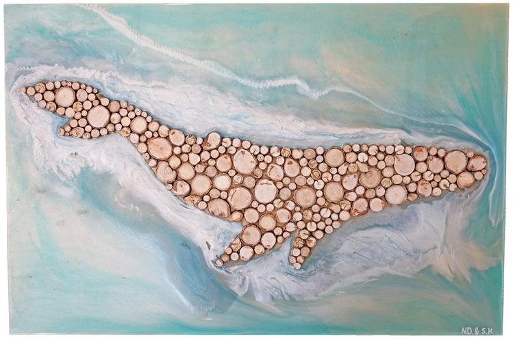 Mixed media artwork that features a whale made of circular wood chips, set against a blue and white epoxy and resin background.