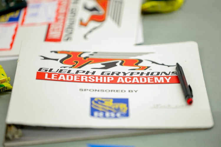 Leadership Academy binder on table.