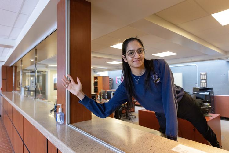 Desk services clerk waving