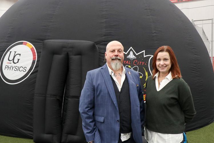 Dr. Joanne O'Meara and Orbax stand with Planetarium