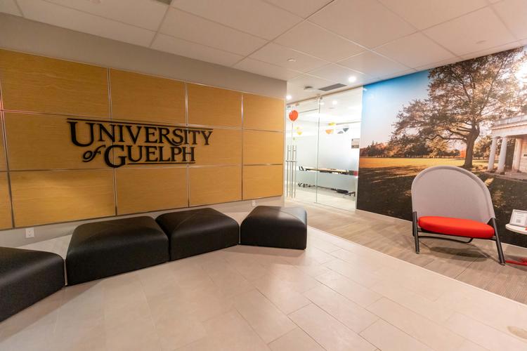 MCTI lobby with chairs, couches, and U of G sign and mural