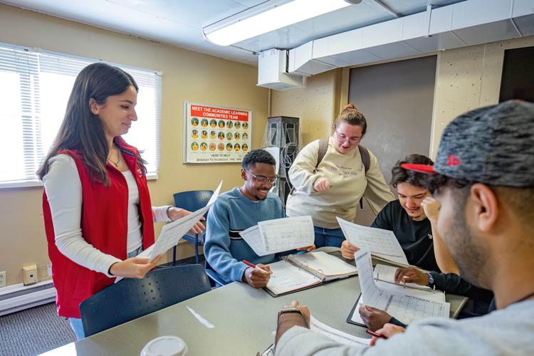 Students studying and chatting in academic support center