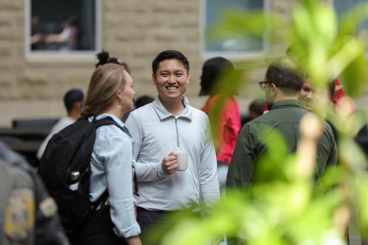 A group of people smiling and talking.