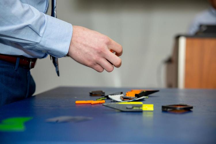 a person's hands assembling a toy