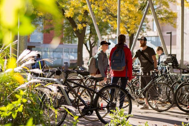 U of G students gather around campus bike shelter.