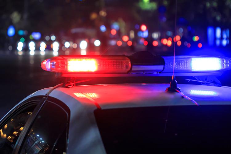 Police cruiser lights flash in the night