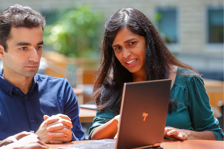 professor with student and lap top