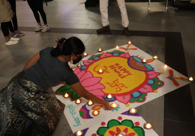 Student lighting diwali candles