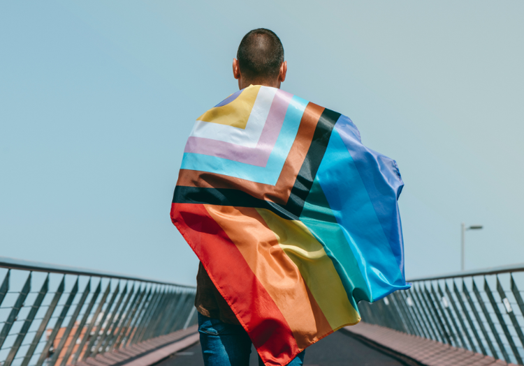 Pride flag over shoulders of human