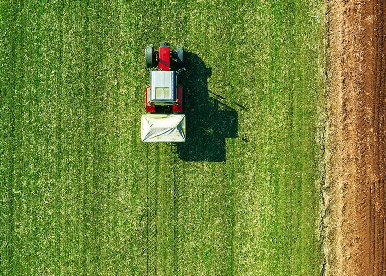 an overhead photo of a tractor plowing a field