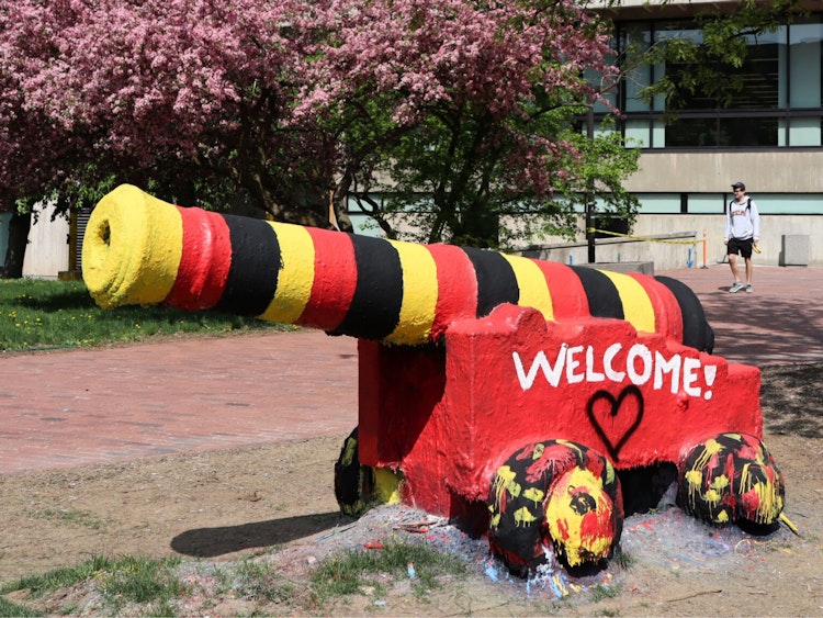 The cannon painted in red, yellow and black with Welcome in white