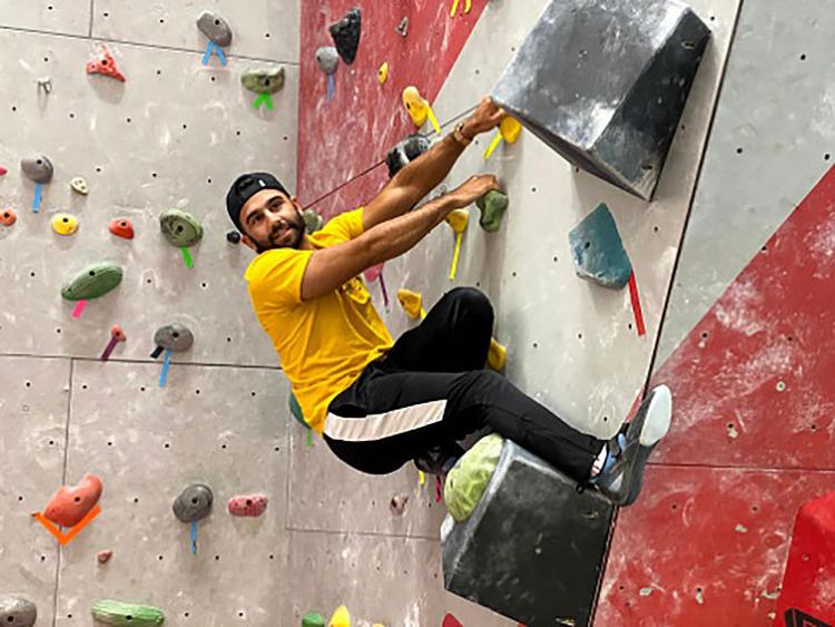 A University of Guelph on the Indoor Rock Climbing Wall at the GGAC