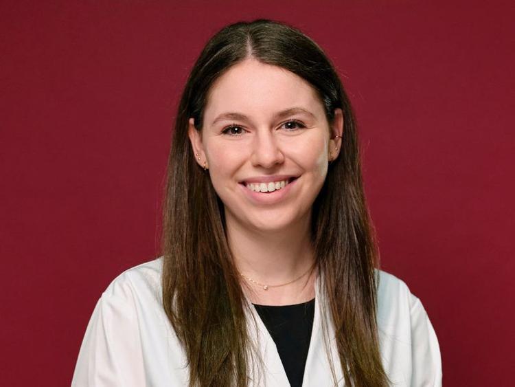 Young grad in lab coat