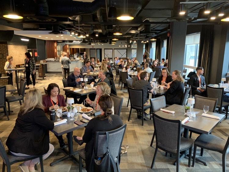 Conference attendees eating breakfast at the University Club.