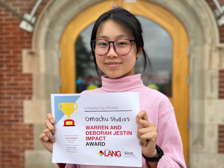Image of a student holding a certificate 