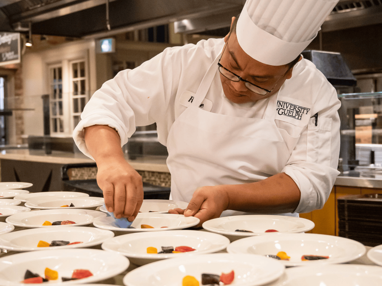 chef wiping salad plates
