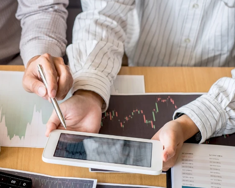 a photo of someone holding a tablet with data displayed