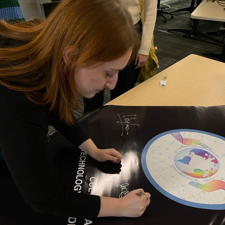 Jacquelyn Passarelli signing a poster