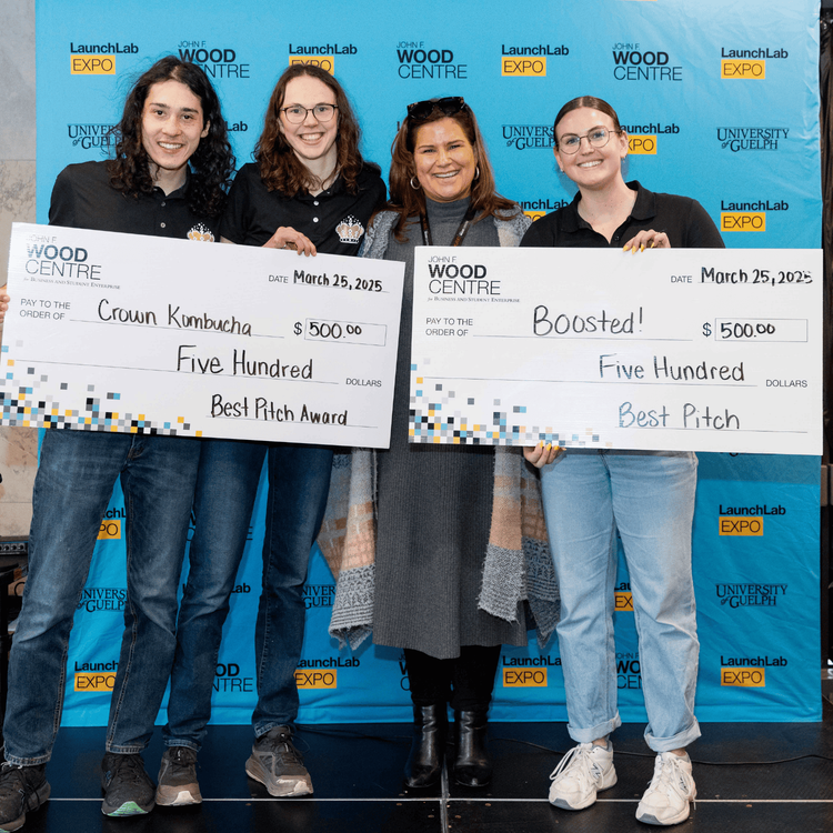 3 individuals holding cheque