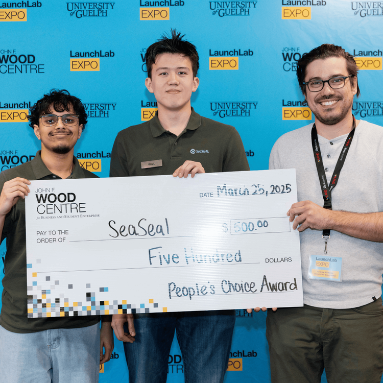 3 individuals holding cheque