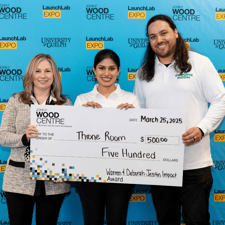 3 individuals holding cheque