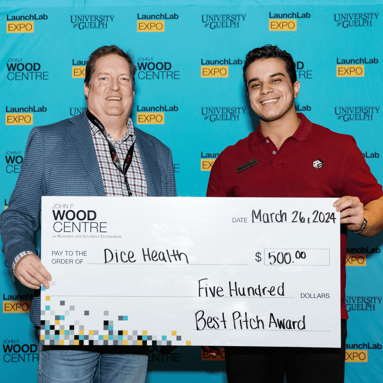 2 individuals holding cheque