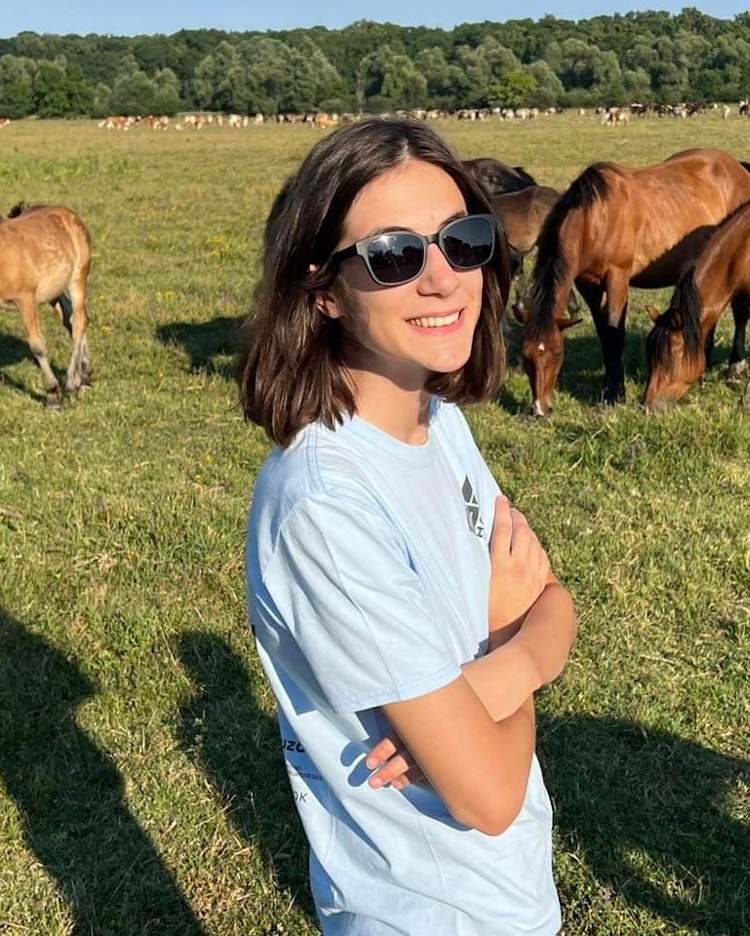 Izabela Savic in a field with horses