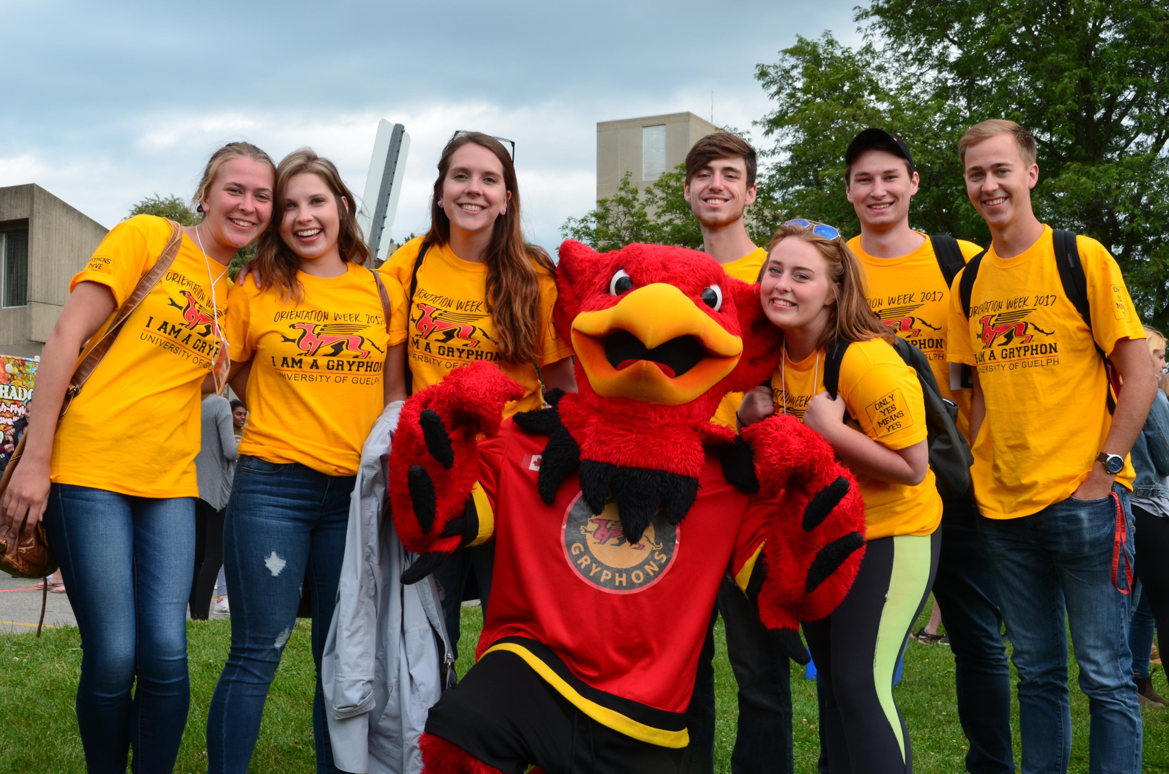 Students posing with Gryph.