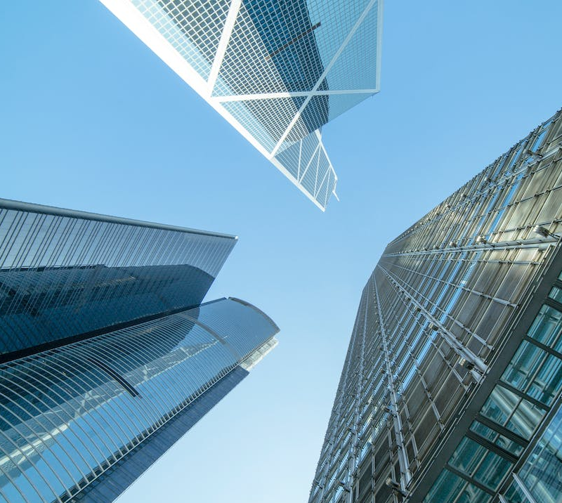 photo of tall business buildings with blue sky